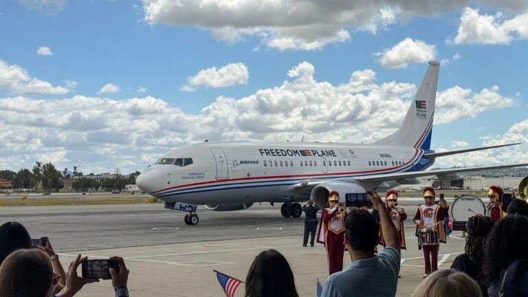 Members of the USC Trojan Marching Band welcome the Freedom Plane